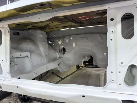 Clean view of stripped car engine bay during the restoration process, showing Stockfoto's