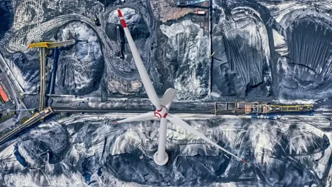 Clean vs dirty energy. Wind turbines against fuel coal power plant. Sustain.. Stock Footage 231489001