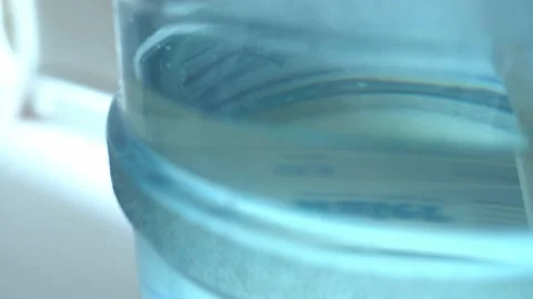 Clean washed plastic bottle of 19 liters, bottom is clean with drinking water Stock Footage 239610705