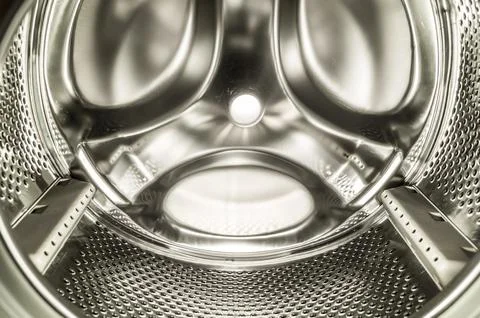 Clean washing machine drum close-up. Shiny inner surface of the drum in the Foto stock