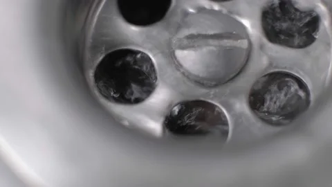Clean water flowing down the drain of a sink in the bathroom. Stock Footage 146473009