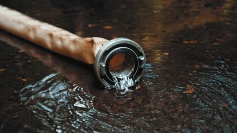 Clean Water Flowing Out of Polyester Fire Hose with Metal Aluminum Coupler Video stock 159510207