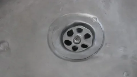 Clean water flowing through the sink drain, water consumption Stock Footage 134452030
