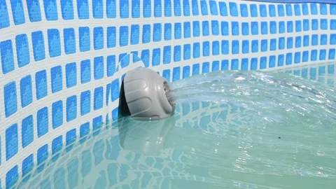 Clean water flows into a frame pool through a filter pump, creating a stream and Stock Footage 300991082