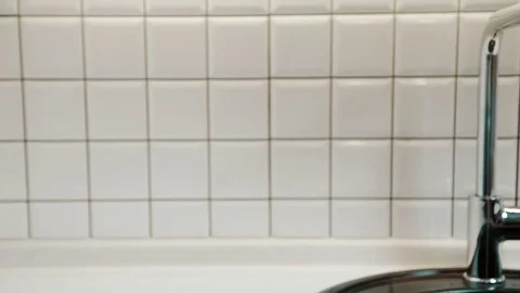 Clean water flows from tap in bathroom of apartment. Stock Footage 82158638