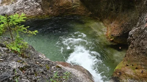 Clean water from a mountain stream flows into a pool Stock-Footage 211467292