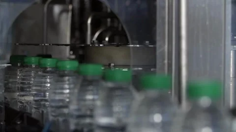 Clean water in plastic bottle moves through conveyor factory. Mineral Water Stock Footage 334587424