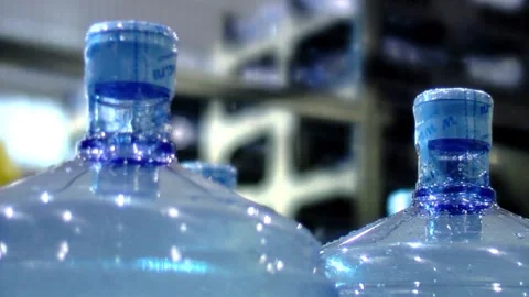 Clean water in plastic bottle moves through conveyor factory. Mineral Water Stock Footage 334587637