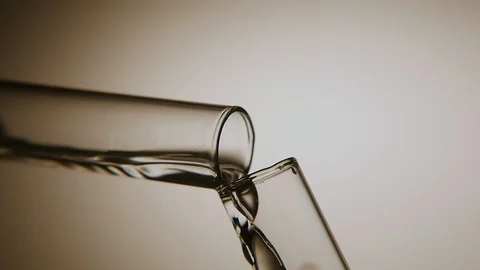 Clean water is poured from one sample tube into another in a chemical lab Stock-Footage 87647420