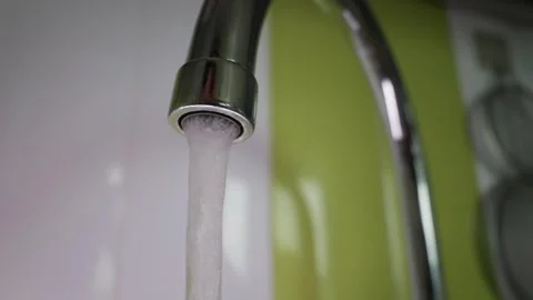 Clean Water Running from Chrome Kitchen Faucet in Slow Motion Video stock 339215499