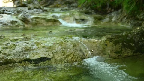 Clean water from a small mountain stream cascades over stones Stock-Footage 211471141