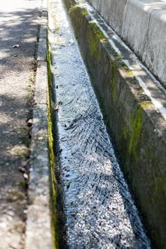 Clean water streaming in concreate made small drainage Stock Photos
