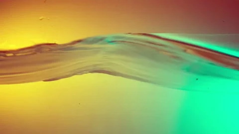 Clean Water Surface Bouncing And Making Splashes on colorful background. Stock Footage 95530337