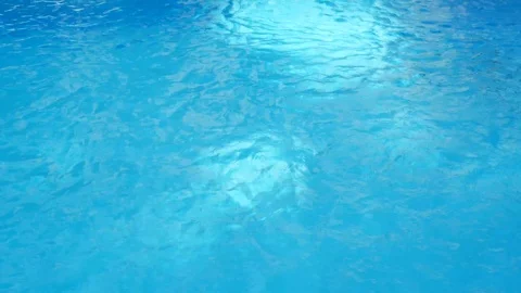 Clean water surface in a swimming pool with blue tiles on the bottom Stock Footage 114826751