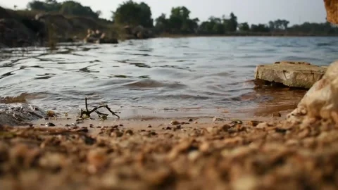 Clean water waves touching the shore in a lake. Stock Footage 131585026