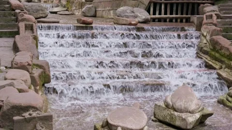 Clean waterfall flows continuously down the stone steps. Stock Footage 328140408