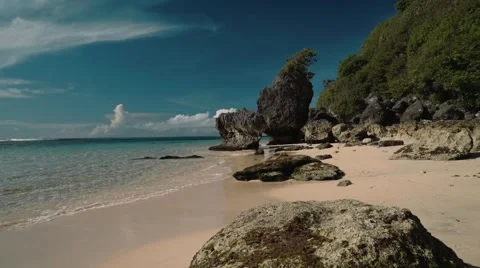 Clean white beach with rocks and cliff - Geger beach, Bali Stock Footage 63620332