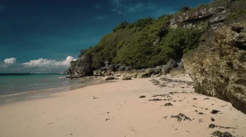 Clean white beach with rocks and cliff - Geger beach, Bali Stock Footage 63620354