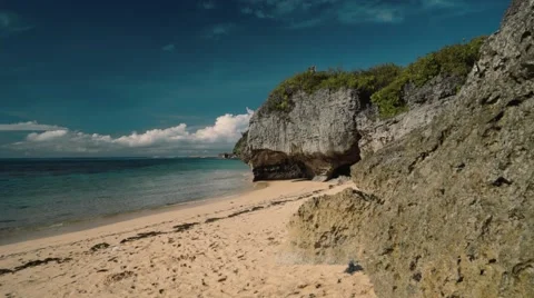 Clean white beach secluded in front of cliffs - Geger beach, Bali Stock Footage 63620362