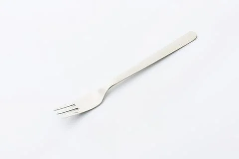 Clean white plastic fork on plain surface Stock Photos