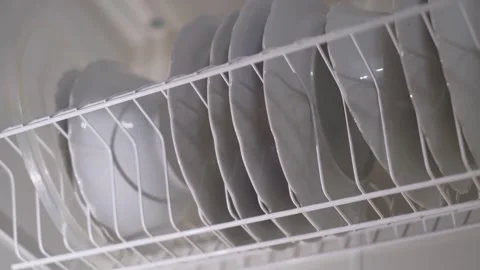 Clean white plates in the kitchen cupboard after washing Stock Footage 301649597