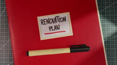 Clean wide view of Renovation Plan red notebook binder Stock Footage 341269361