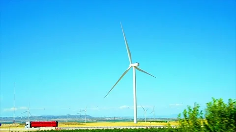 Clean wind power generation with Eólica on yellow field, View from a car window Stock Footage 201190312
