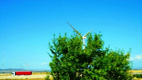 Clean wind power generation with Eólica on yellow field, View from a car window Stock Footage 201190327
