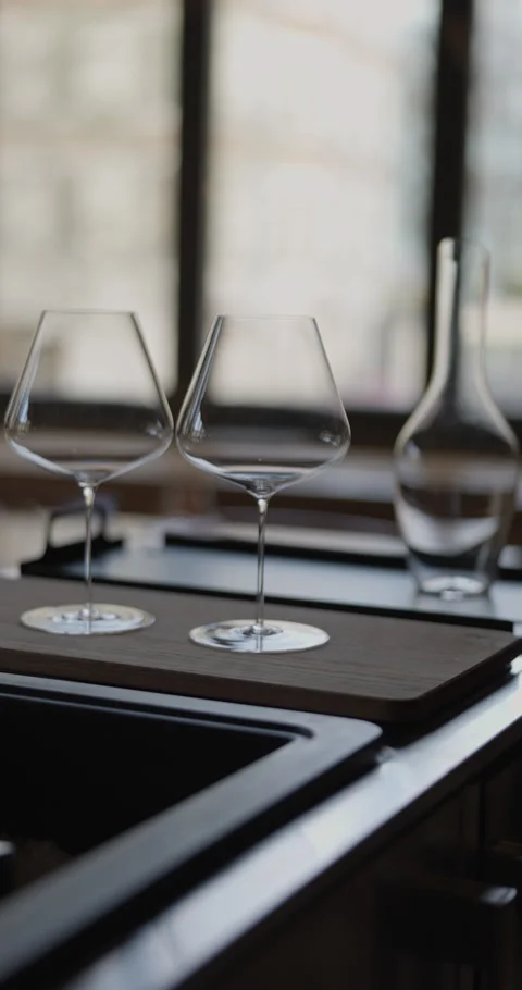 Clean wine glasses are on the table of a special wine cabinet, stylish table Video stock 309055610