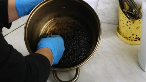 Clean with a wire brush the burnt pan.Cleaning in the home kitchen. Stock Footage