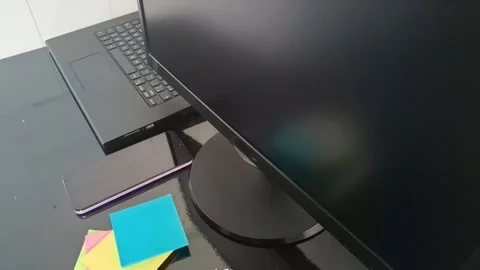 Clean workspace desk setup with black monitor and laptop motion footage Stock Footage 340038097