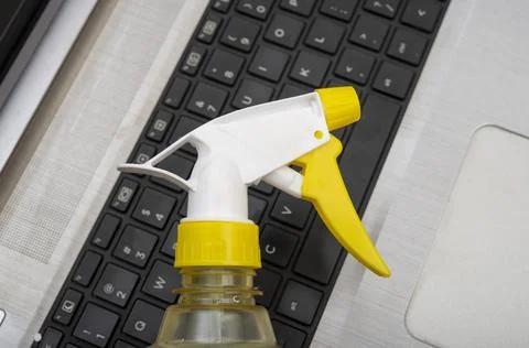 Clean your computer concept with water sparyer on top of keys Stock Photos