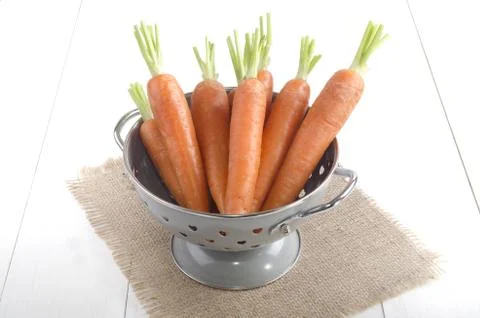 Cleaned carrots in a colander Stock Photos