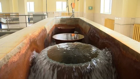 Cleaned water flow through round tubes and hand with jar draw it. Stock Footage 112574780