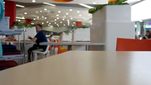 Cleaner is cleaned on the table in a fast food cafe. Restaurant staff member are Stock Footage 279148759