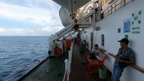 Cleaner cleaning deck of a ship in the open ocean Stock Footage 127511346