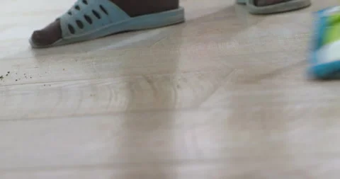 The cleaner cleans the laminate floor with a mop. Stock Footage 309116213
