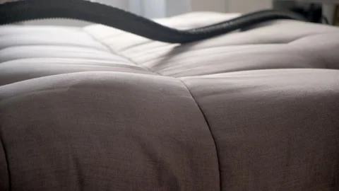 Cleaner hands using vacuum cleaner to meticulously clean sofa from stains dust. Stock Footage 311800645