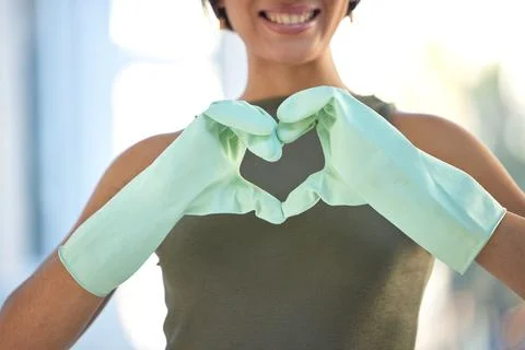 Cleaner with heart hand, love cleaning with woman, housekeeping with gloves for Stock Photos