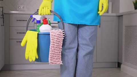 Cleaner inside building holding blue bucket filled with chemicals in her hand. Stock Footage 231329791
