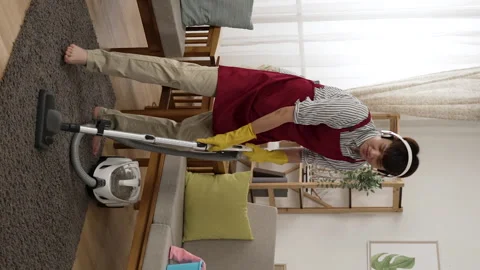 Cleaner man with headphones is having fun Stock Footage 229618085