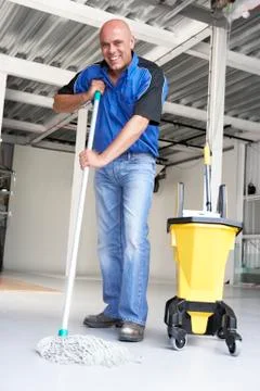 Cleaner mopping office floor Stock Photos