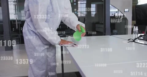 Cleaner sanitizing office table by spraying from green bottle and wiping with Video stock 328358311