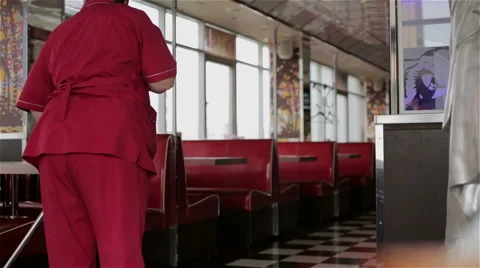 Cleaner washes a floor in the Cafe Stock Footage 48910196