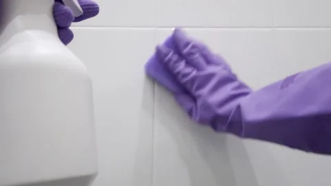 The cleaner washes the tiled wall in the bathroom. First-person view. POV Stock Footage 201107372