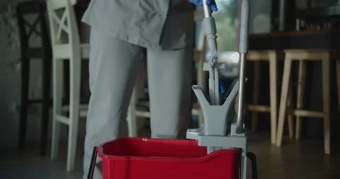 Cleaner work at the cafe. Squeeze mop in the bucket Stock-Footage 138096088