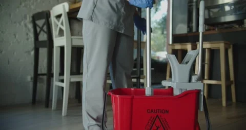 Cleaner work at the cafe. Squeeze mop in the bucket Stock-Footage 138096340