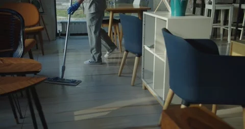 Cleaner work at the cafe. Wash floor with the mop. Stock Footage 138096181