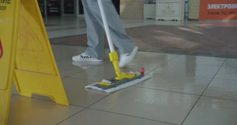 Cleaner work at the mall. Wash floor with the mop. Stock-Footage 138089633