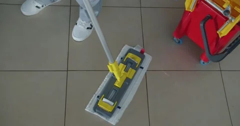 Cleaner work at the mall. Wash floor with the mop. Stock Footage 138089733
